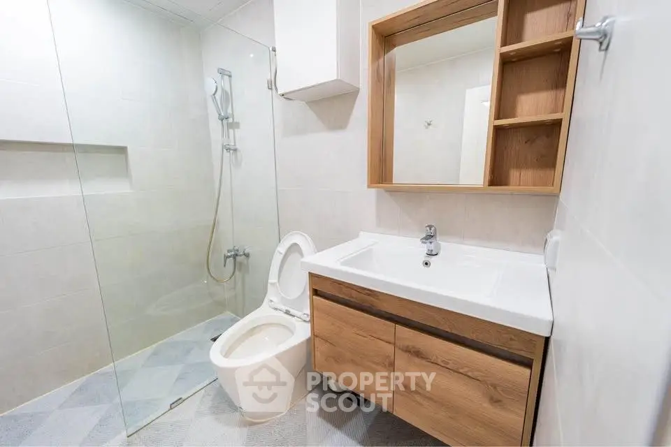 Modern bathroom with glass shower and wooden vanity unit