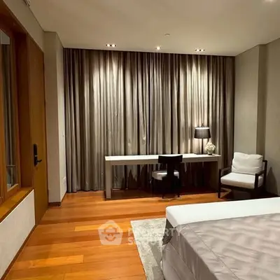 Elegant bedroom with wooden flooring and modern furnishings