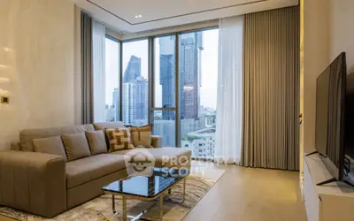 Modern living room with city view, featuring a stylish sofa and floor-to-ceiling windows.