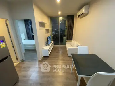 Modern apartment living room with sleek furniture and city view