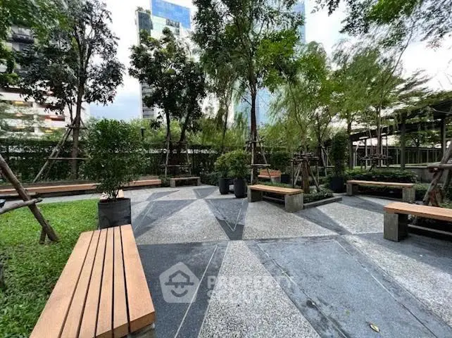 Tranquil urban garden with benches and lush greenery, perfect for relaxation and outdoor enjoyment.