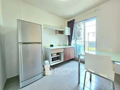 Modern kitchen with stainless steel fridge and balcony access