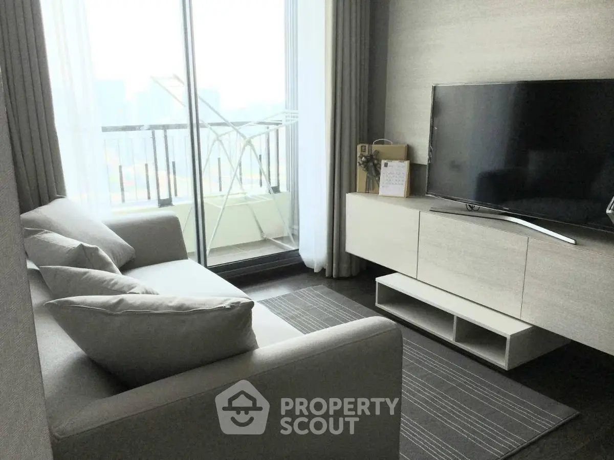 Modern living room with sleek furniture and balcony view, perfect for urban living.