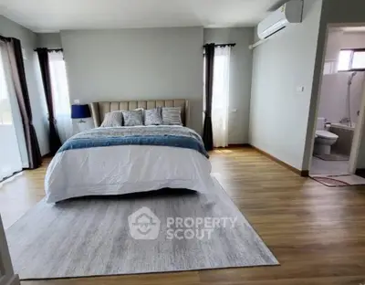 Spacious bedroom with modern decor and ensuite bathroom