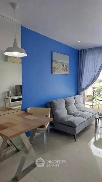 Modern living room with blue accent wall and cozy furnishings