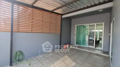 Modern covered patio with sliding glass doors and tiled flooring.