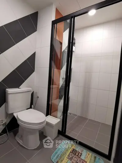 Modern bathroom with sleek shower enclosure and stylish tile design