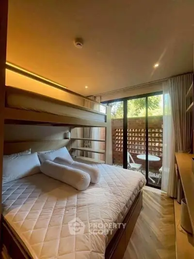 Cozy bedroom with bunk bed and large window overlooking garden, perfect for family living.