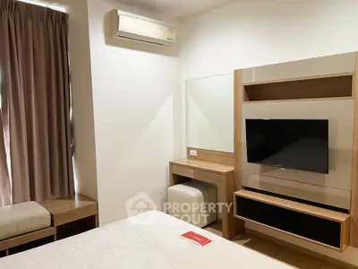 Modern bedroom with air conditioning and stylish wooden furniture