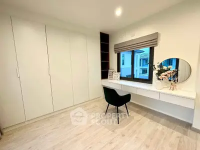 Modern bedroom with built-in wardrobe and stylish vanity area