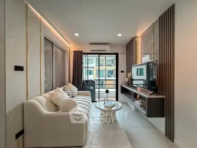 Modern living room with stylish decor and balcony view in a contemporary apartment.