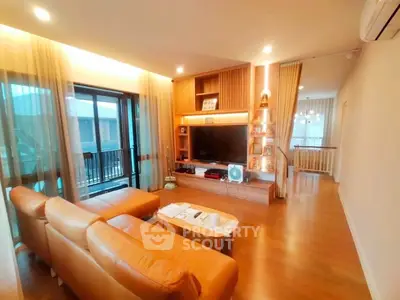 Spacious living room with modern decor and large windows for natural light.