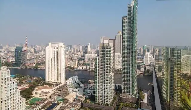 Stunning cityscape view with modern high-rise buildings and river backdrop.