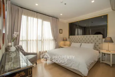 Luxurious bedroom with elegant decor and large window in modern apartment