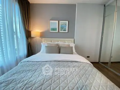Cozy bedroom with elegant decor and ample natural light, featuring a comfortable bed and stylish furnishings.