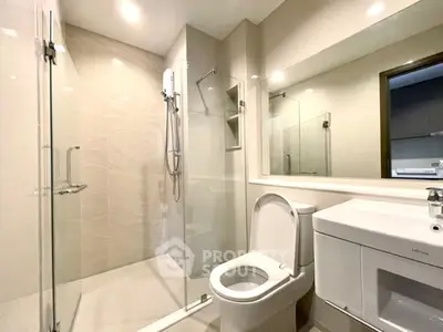 Modern bathroom with glass shower and sleek fixtures