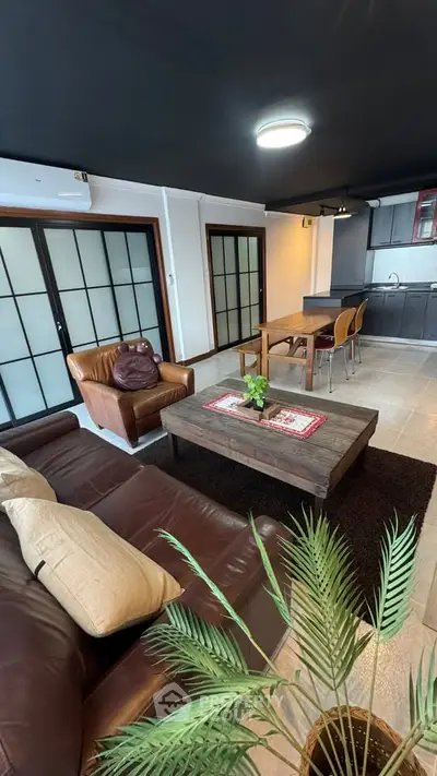 Spacious open-plan living room with modern kitchen and stylish decor