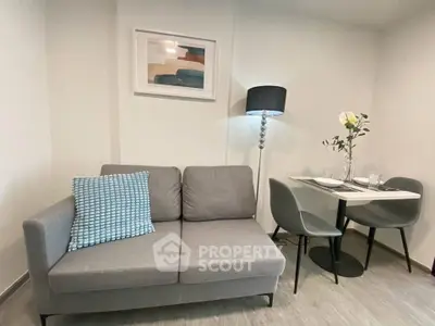 Cozy living room with modern gray sofa and stylish dining area