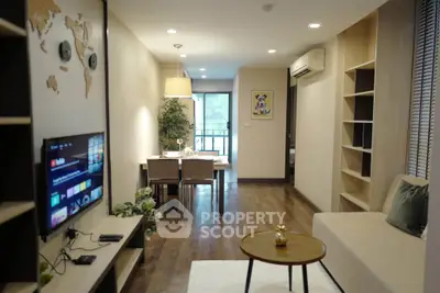 Modern living room with dining area and stylish decor in a cozy apartment.