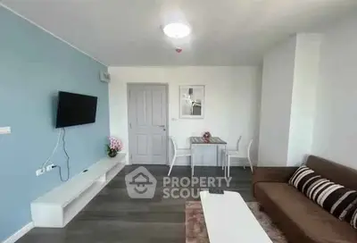 Modern living room with stylish decor and wall-mounted TV in a cozy apartment.