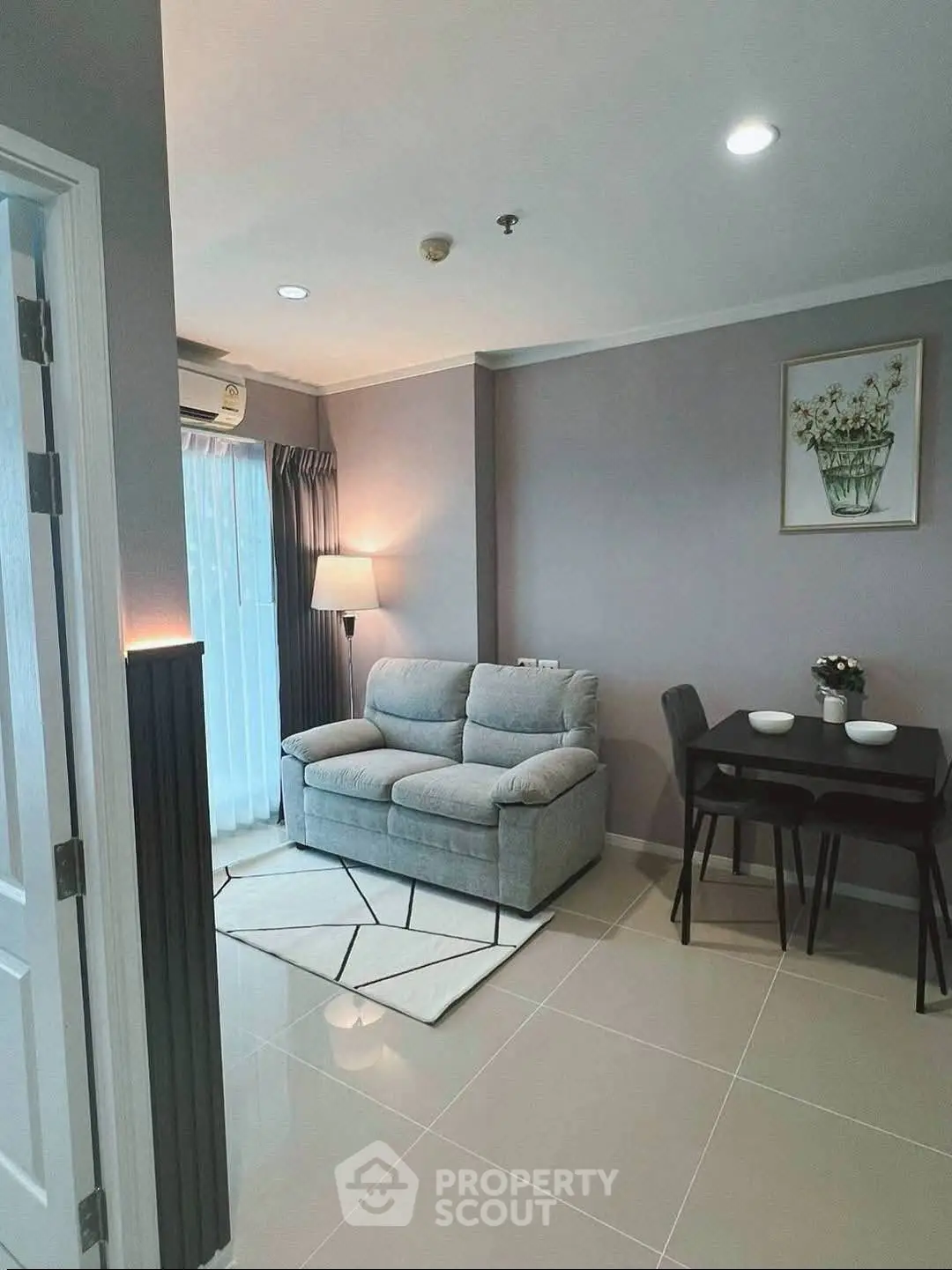 Cozy living room with modern decor and dining area in stylish apartment.