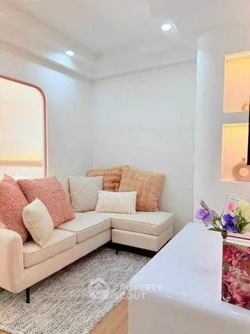 Charming living room with cozy L-shaped sofa and soft lighting, perfect for relaxation.