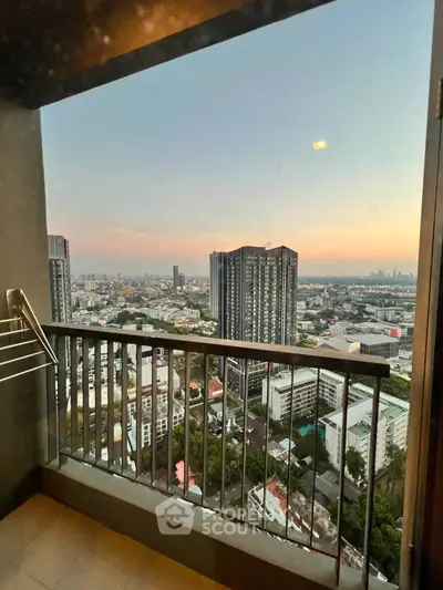 Stunning high-rise balcony view with cityscape at sunset, perfect for urban living enthusiasts.