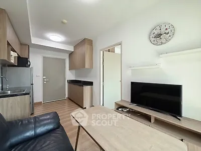 Modern living room with sleek furniture and open kitchen layout