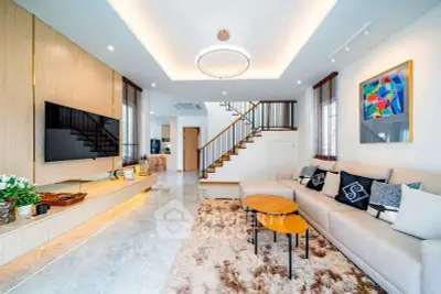 Spacious modern living room with stylish decor and cozy seating area.