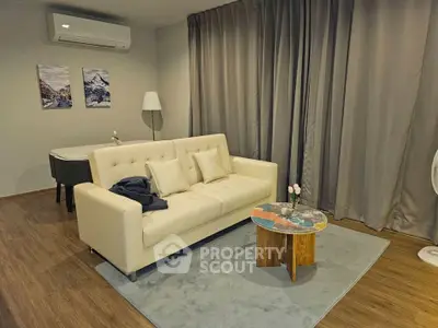 Modern living room with stylish sofa, air conditioning, and elegant decor.