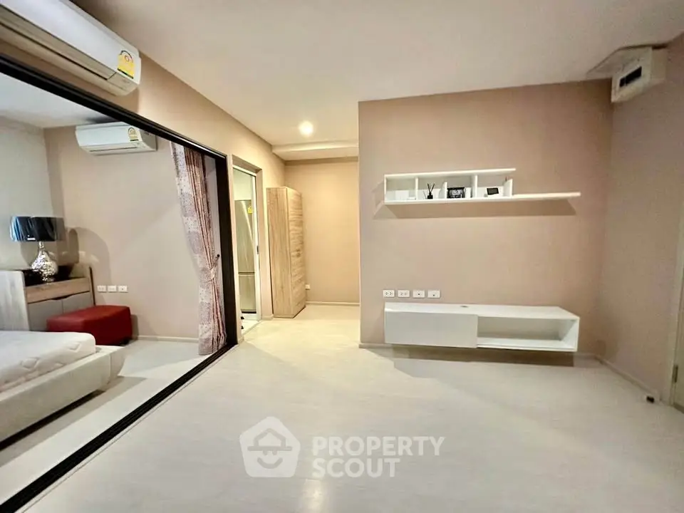 Spacious modern living room with sleek design and ample natural light, perfect for comfortable living.