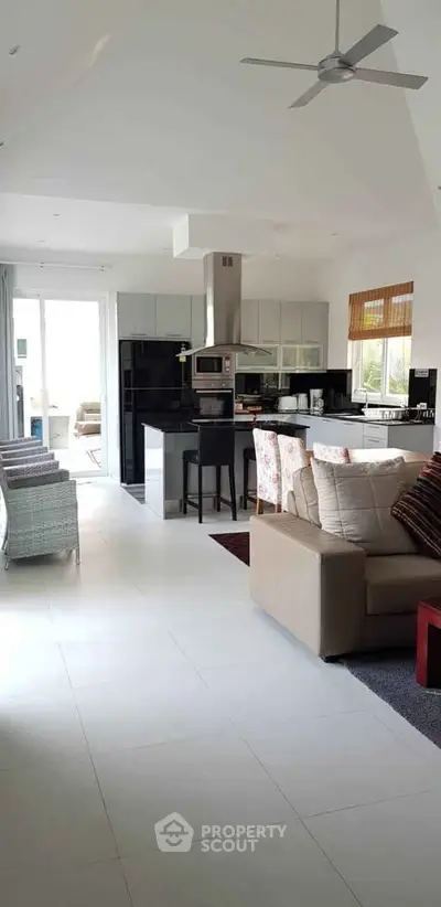 Spacious open-plan living room with modern kitchen and stylish decor