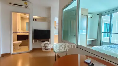 Modern apartment interior with open layout, featuring a cozy living area, bedroom, and bathroom.
