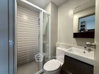 Modern bathroom with sleek design featuring a glass shower enclosure and stylish vanity.