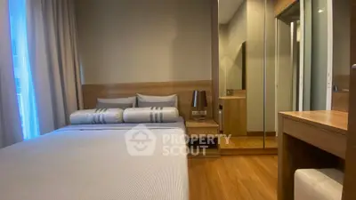 Modern bedroom with wooden flooring and mirrored wardrobe, cozy and inviting ambiance.