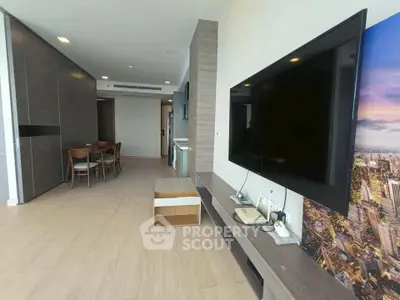Spacious modern living room with large TV and stylish decor