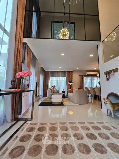 Luxurious modern living room with high ceilings, elegant decor, and large windows for natural light.