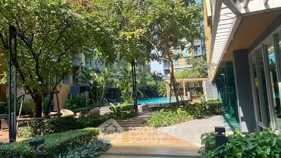 Luxurious apartment complex with lush garden and inviting pool area