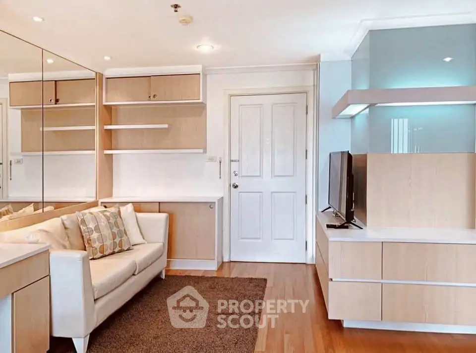 Modern living room with sleek wooden furniture and cozy sofa in a bright apartment.