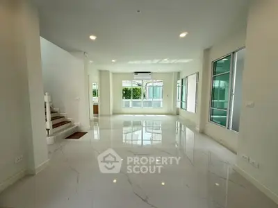 Spacious modern living room with glossy floors and large windows