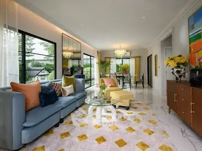 Luxurious living room with elegant decor and large windows offering a serene garden view.