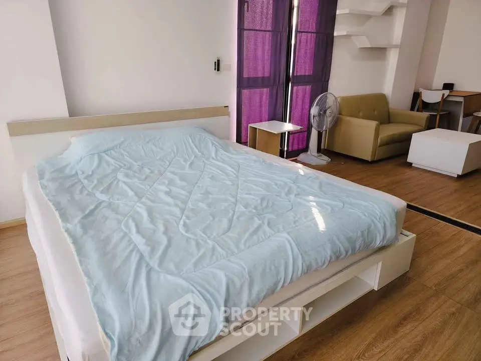 Spacious bedroom with modern furniture and natural light