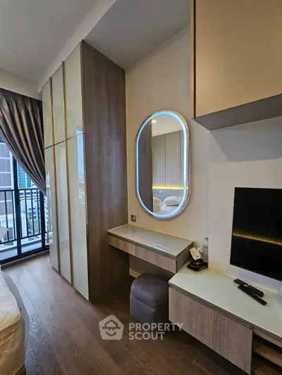 Modern bedroom with stylish furniture and balcony view in a high-rise apartment.
