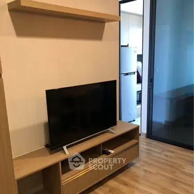 Modern living room with sleek TV stand and wooden flooring