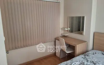 Cozy bedroom with study desk and modern decor, perfect for relaxation and productivity.