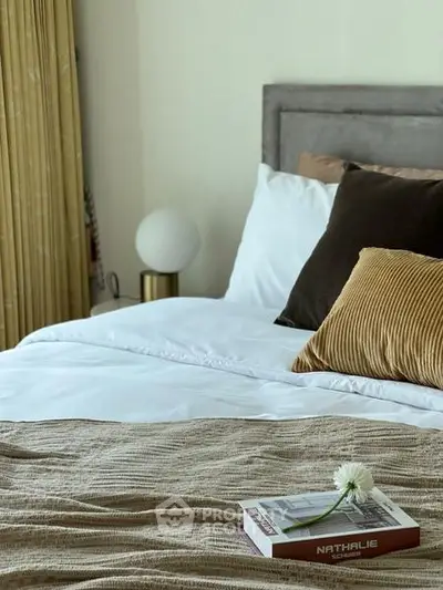 Cozy bedroom with stylish decor and plush pillows, perfect for relaxation.