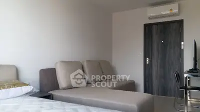 Modern studio apartment with sleek furniture and air conditioning