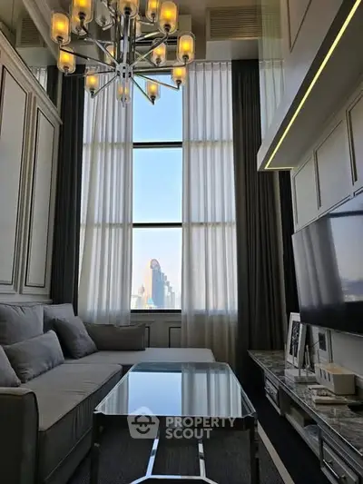 Luxurious high-ceiling living room with modern chandelier and city view