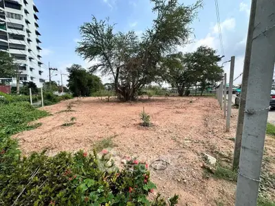 Prime vacant land plot with potential for development, surrounded by greenery and urban infrastructure.