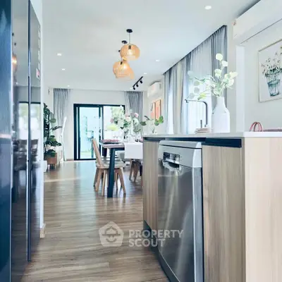 Modern open-plan kitchen and dining area with stylish decor and natural light.